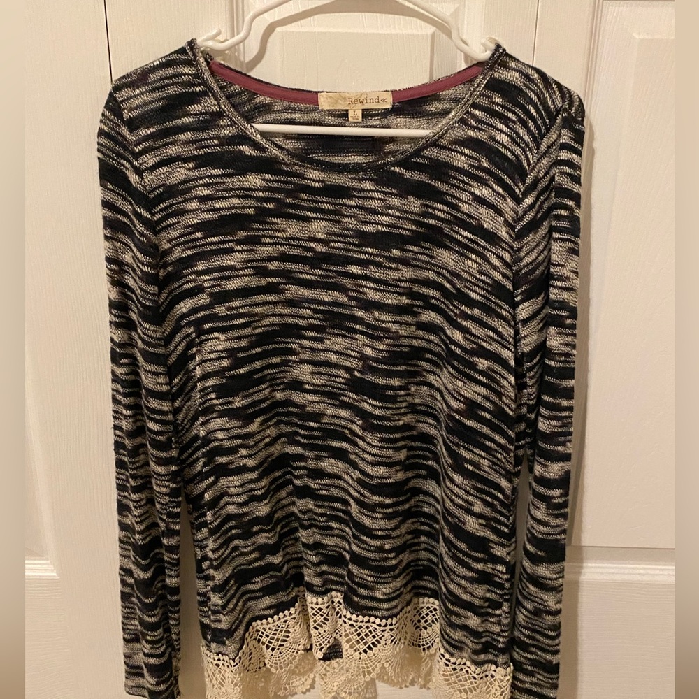 Black and white long sleeve sweater with hem detailing